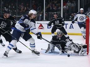 Jonathan Quick (32) of the Los Angeles Kings makes a save on a shot from Kyle Connor (81) of the Winnipeg Jets as Olli Maatta #6 looks on during the first period at Staples Center on Oct. 28, 2021 in Los Angeles, Calif.