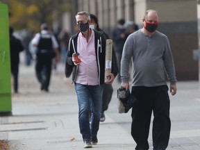 People walking in public, while wearing masks, in Winnipeg on Friday, Oct. 1, 2021.