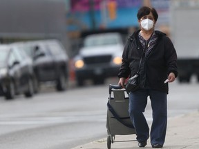 A person walking in public, while wearing a mask, in Winnipeg on Friday, Oct. 1, 2021.
