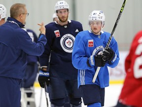 Cole Perfetti (right) listens to head coach Paul Maurice during Winnipeg Jets training camp at BellMTS Iceplex in Winnipeg on Tues., Oct. 5, 2021. KEVIN KING/Winnipeg Sun/Postmedia Network