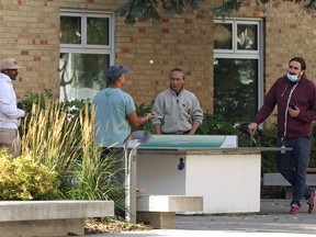 Health care employees play table tennis outside the Health Sciences Centre’s Lennox Bell Lodge, a transitional housing project, in Winnipeg on Monday, Oct. 18, 2021. KEVIN KING/Winnipeg Sun