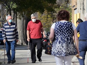 Pedestrians on a Notre Dame Avenue sidewalk in Winnipeg on Monday Oct. 18, 2021.