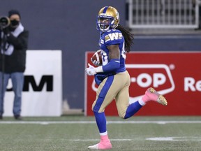 Winnipeg Blue Bombers KR Janarion Grant checks for would-be B.C. Lions tacklers as he takes a punt return in for a touchdown at IG Field in Winnipeg on Saturday, Oct. 23, 2021.