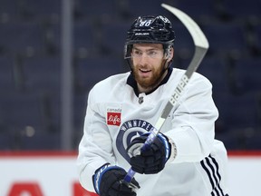 Pierre-Luc Dubois follows through on a backhand shot during Winnipeg Jets practice at Canada Life Centre on Monday, Oct. 25, 2021.