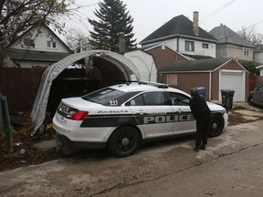 Police investigate at the scene of a homicide in the 300 block of Toronto Street, in Winnipeg on Thursday, Oct. 28, 2021.