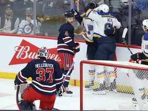 The St. Louis Blues celebrate a goal from Pavel Buchnevich with Winnipeg Jets defenceman Neal Pionk (left) looking on.