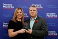 Dr. Candace Bradshaw, president-Elect of Doctors Manitoba, presents and Dr. Ken Hahlweg with a Special Award for Bravery on Wednesday, Nov. 11, 2021 in Winnipeg. Handout/Doctors Manitoba/Winnipeg Sun
