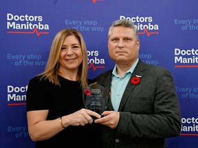 Dr. Candace Bradshaw, president-Elect of Doctors Manitoba, presents and Dr. Ken Hahlweg with a Special Award for Bravery on Wednesday, Nov. 11, 2021 in Winnipeg. Handout/Doctors Manitoba/Winnipeg Sun