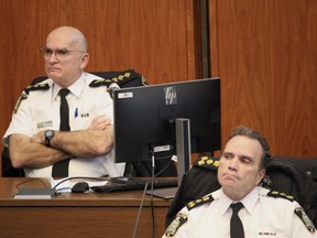 Winnipeg Police Service Chief Danny Smyth and Deputy Chief Art Stannard listen to Coun. Sherri Rollins at City Hall on Friday prior to a Finance Committee vote that awarded police a multimillion dollar 2021 over-expenditure.   James Snell/Winnipeg Sun