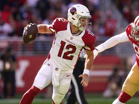 Arizona Cardinals quarterback Colt McCoy tries to elude pressure from San Francisco 49ers defensive end Arik Armstead.