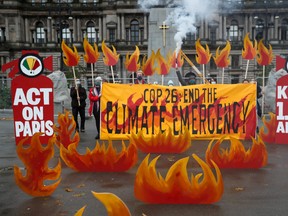 Activists symbolically set George Square on fire with an art installation of faux flames and smoke ahead of the UN Climate Change Conference (COP26), in Glasgow, Scotland, October 28, 2021.