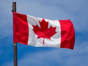 A Canadian flag flies above the Big Four building at the Calgary Stampede grounds, June 17, 2021.