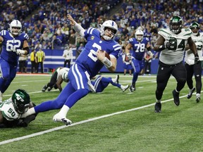Colts quarterback Carson Wentz runs the ball as Shaq Lawson of the Jets, left, defends during second half NFL action at Lucas Oil Stadium in Indianapolis, Thursday, Nov. 4, 2021.