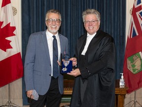 Canadian gospel music artist Steve Bell and Chief Justice Richard J. F. Chartier pose for a photo during Bell’s induction ceremony on Oct. 28.