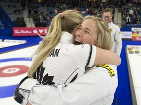 Skip Jennifer Jones of Winnipeg celebrates with second Jocelyn Peterman after defeating Team Fleury 6-5 in extra end to capture the woman's curling trials in Saskatoon on Nov. 28, 2021.
