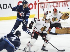 Winnipeg Jets' Neal Pionk scores on Chicago Blackhawks goaltender Marc-Andre Fleury. John Woods/The Canadian Press