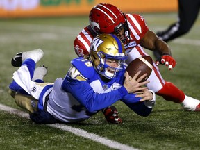 Stampeders’ Jameer Thurman tackles Blue Bombers quarterback Dru Brown to cause a fumble in Calgary last night.