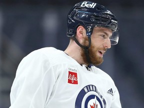 Pierre-Luc Dubois jokes with a teammate during Winnipeg Jets practice at Canada Life Centre on Oct. 25, 2021.