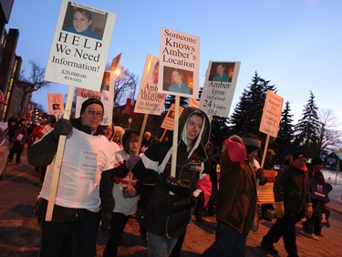 Marchers including family members carry signs showing Amber McFarland, the Portage la Prairie woman who went missing on Oct. 18, 2008, after last being seen at a nightclub in her hometown. during the third annual Memorial March for Missing and Murdered Women in Manitoba Sunday, Feb. 14, 2010 in downtown Winnipeg.