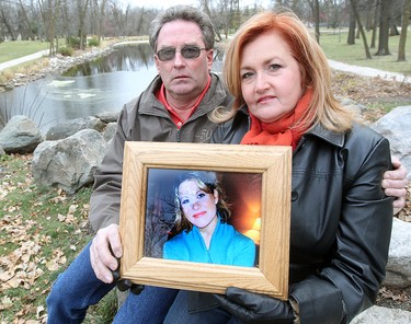 Scott (left) and Lori McFarland hold a photo of Amber McFarland in Portage La Prairie, Manitoba Saturday October 27, 2012. Amber has been missing since October 2008.