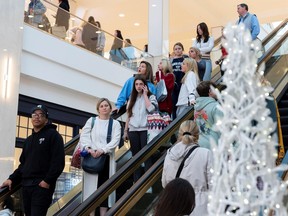 People ride on the elevator as shoppers show up early for the Black Friday sales at the King of Prussia shopping mall in King of Prussia, Pennsylvania, U.S. November 26, 2021.  REUTERS/Rachel Wisniewski