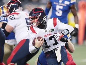 Montreal Alouettes quarterback Trevor Harris (17) is tackled from behind during a Canadian football League game at IG Field in Winnipeg on Nov. 6, 2021.