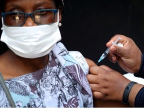 A healthcare worker administers the Johnson and Johnson coronavirus disease (COVID-19) vaccination to a woman in Houghton, Johannesburg, South Africa, August 20, 2021.