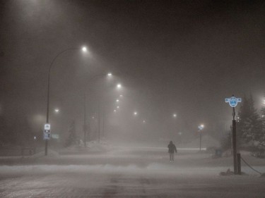 A person walks down Kelsey Boulevard during a blizzard in Churchill, Man., on Nov. 21, 2021.