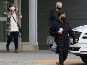 Three people wear masks while in public in Winnipeg on Friday, Nov. 5. 2021.