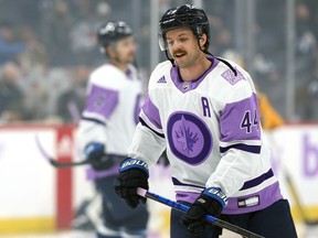 Winnipeg Jets defenceman Josh Morrissey skates in a Hockey Fights Cancer jersey ahead of a game against the Pittsburgh Penguins in Winnipeg on Monday, Nov. 22, 2021.