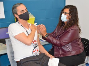 Dr. Marcia Anderson, the public health lead for the First Nations pandemic response co-ordination team, administered a COVID-19 booster shot to Assembly of Manitoba Chiefs Grand Chief Arlen Dumas on Monday, Nov. 29, 2021, at the Urban Indigenous Vaccination Centre on McGregor Street in Winnipeg.