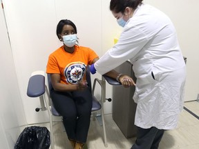 Health Minister Audrey Gordon is tested for diabetes at a mobile clinic at Maples Community Centre on Adsum Drive in Winnipeg on Sunday, Nov. 28, 2021.