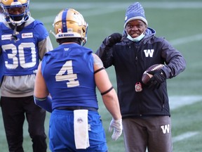 Defensive co-ordinator Richie Hall (right) speaks with linebacker Adam Bighill during Winnipeg Blue Bombers practice on Sunday, Nov. 28, 2021.