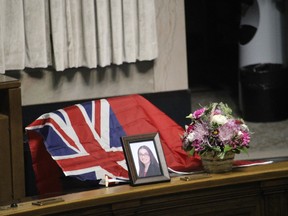 Members of Mantoba's NDP party placed a flag and portrait on NDP MLA Danielle Adams' seat and desk during a memorial gathering in the house on Dec. 13, 2021. Adams died in a traffic accident on Dec. 9, 2021 while traveling from Thompson to Winnipeg. She was honoured in the Manitoba Legislature Tuesday as members spent the day expressing condolences to her family.