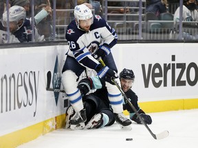 Mark Giordano (5) of the Seattle Kraken tries to play the puck as Blake Wheeler (26) of the Winnipeg Jets looks to pass during the first period at Climate Pledge Arena on Dec. 9, 2021 in Seattle.