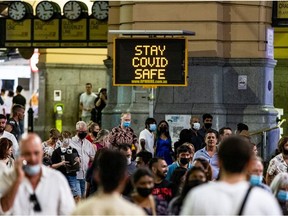 A signage is seen in front of Flinders Street Station as people walk past during New Year's Eve celebrations on December 31, 2021 in Melbourne, Australia.