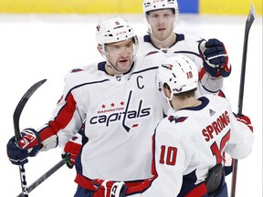Washington Capitals left wing Alex Ovechkin (8) celebrates his third period goal with Washington Capitals right wing Daniel Sprong (10) against the Winnipeg Jets at Canada Life Centre in Winnipeg on Dec. 17, 2021.