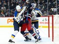 St. Louis Blues defenceman Niko Mikkola (77) battles for position with Winnipeg Jets forward Pierre-Luc Dubois (80) during the second period at Canada Life Centre in Winnipeg on Dec. 19, 2021.