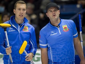 Brendan Bottcher, left, and Darren Moulding are pictured playing against Team Gushue at the Tim Horton’s curling trials on Nov. 20, 2021.