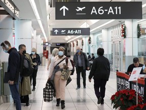 United States-bound passengers walk in Toronto Pearson Airport's Terminal 3, days before new COVID-19 testing protocols to enter the U.S. come into effect, in Toronto, Dec. 3, 2021.