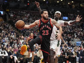 Raptors' Fred VanVleet passes the ball as Milwaukee Bucks' Bobby Portis defends during the second quarter at Scotiabank Arena on Thursday, Dec. 2. 2021.