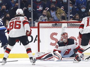 Winnipeg Jets center Mark Scheifele (55) scores on New Jersey Devils goaltender Jonathan Bernier (45) in the first period at Canada Life Centre in Winnipeg on Dec. 3, 2021.