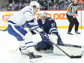 Winnipeg Jets goalie Connor Hellebuyck stops Leafs forward John Tavares last night.  USA TODAY Sports