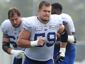Centre Michael Couture runs a drill with the offensive line during Winnipeg Blue Bombers practice on the University of Manitoba campus in Winnipeg on Thursday, July 22, 2021.