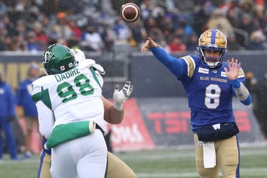 Winnipeg Blue Bombers QB Zach Collaros (right) throws against the Saskatchewan Roughriders in the CFL West Final in Winnipeg on Sun., Dec. 5, 2021.  KEVIN KING/Winnipeg Sun/Postmedia Network