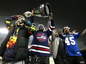 Winston Rose holds the trophy as the Winnipeg Blue Bombers celebrated its 2021 Grey Cup win at IG Field on Wednesday.