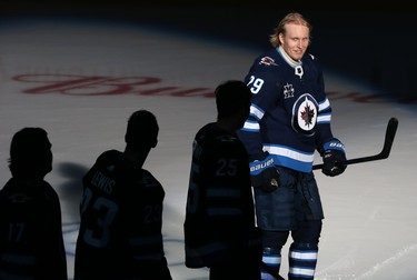 Winnipeg Jets forward Patrik Laine smiles at teammates during player introductions before facing the Calgary Flames during NHL action in Winnipeg on Thurs., Jan. 14, 2021. Kevin King/Winnipeg Sun/Postmedia Network