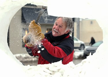 Gary Tessier carves a snow sculpture on Provencher Boulevard in Winnipeg on Wed., Feb. 3, 2021. Kevin King/Winnipeg Sun/Postmedia Network