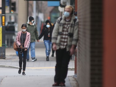 A group of people wear masks while in public in Winnipeg on October 29. Chris Procaylo/Winnipeg Sun