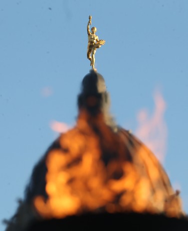 The Centennial Flame creates the illusion that the Manitoba Legislative Building is engulfed in flames in Winnipeg on October 30. Chris Procaylo/Winnipeg Sun